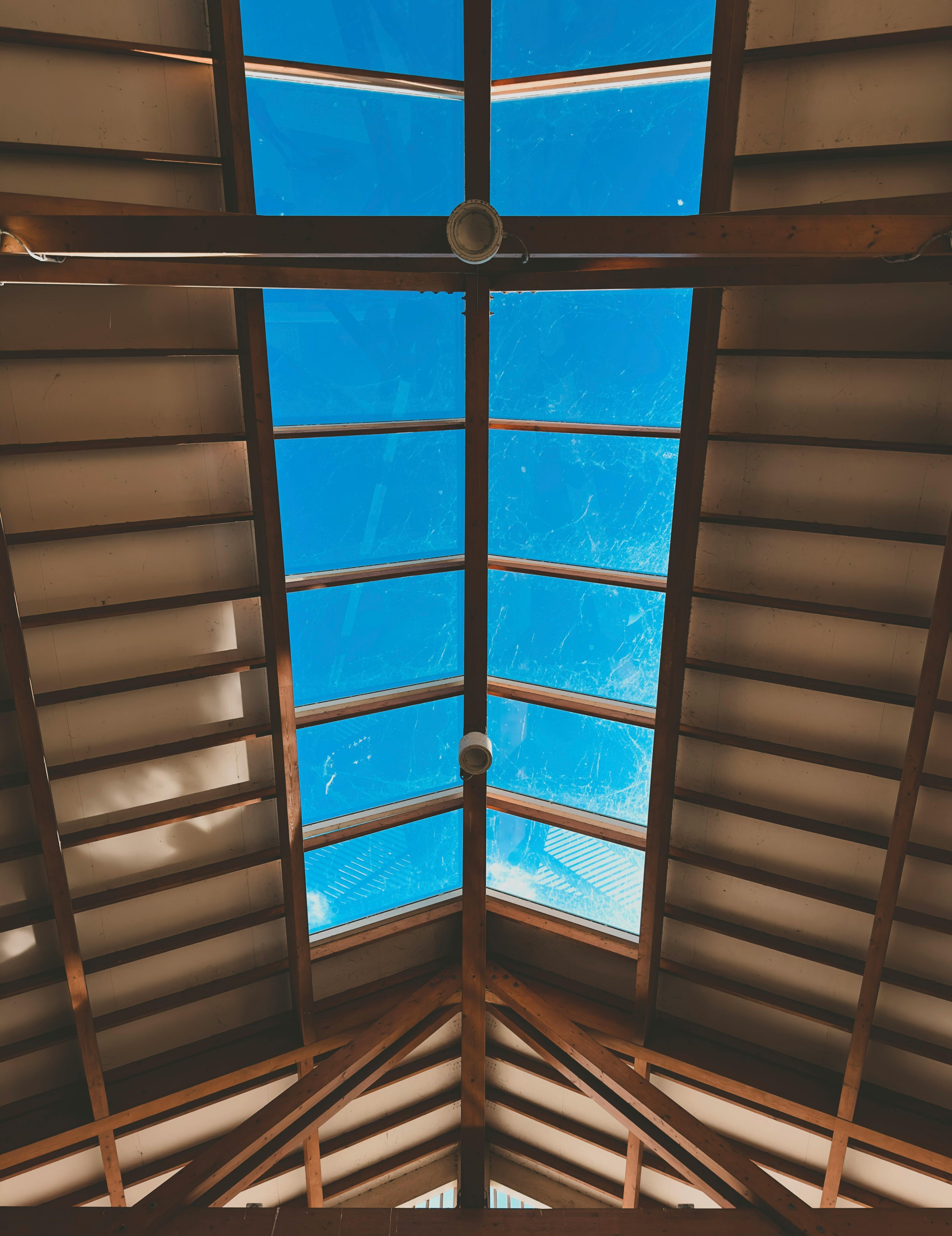 Wooden ceiling with a skylight showing blue sky